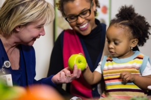 mother & daughter with health care worker