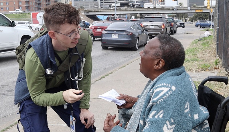 Dr. Michael Stefanowicz talking to someone in a wheel chair