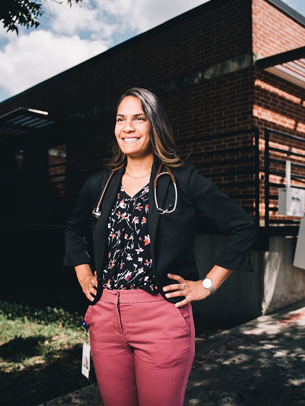 Dr. Patel in front of building