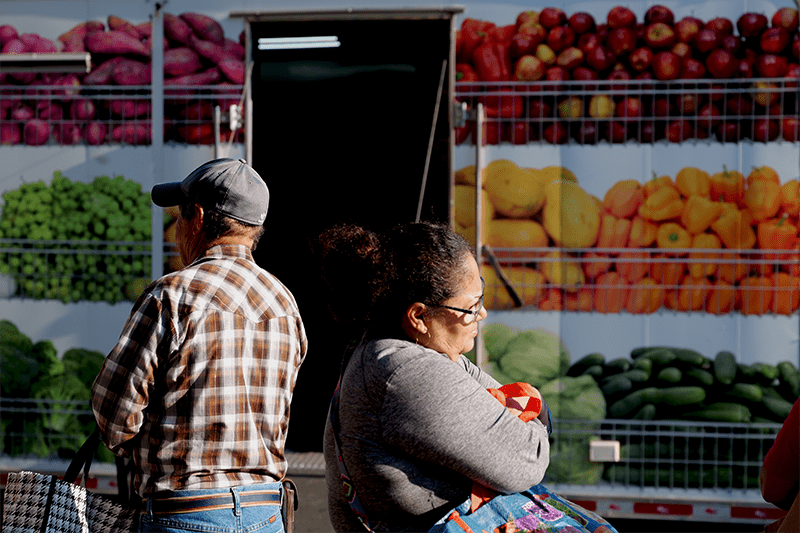 people in front of mobile pantry