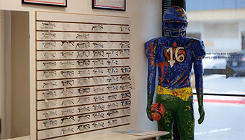 glasses on shelf and football player statue