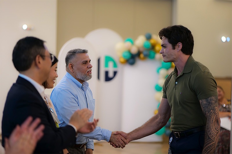 CHW graduate shaking hands