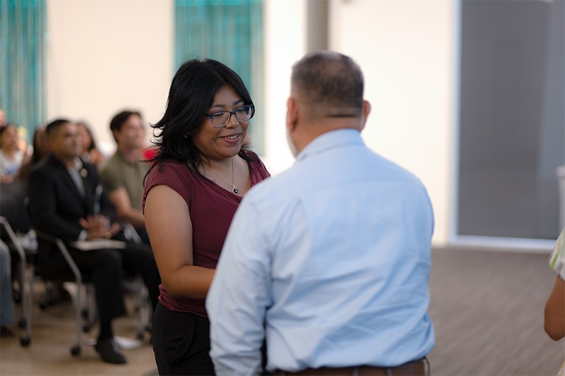 CHW graduate shaking hands