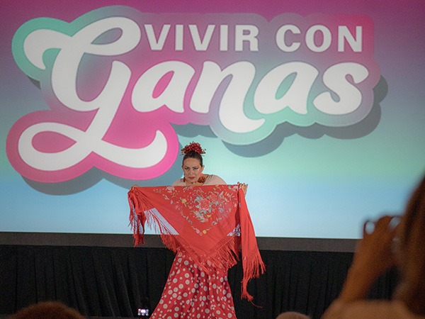 woman on stage with a scarf held in front of her